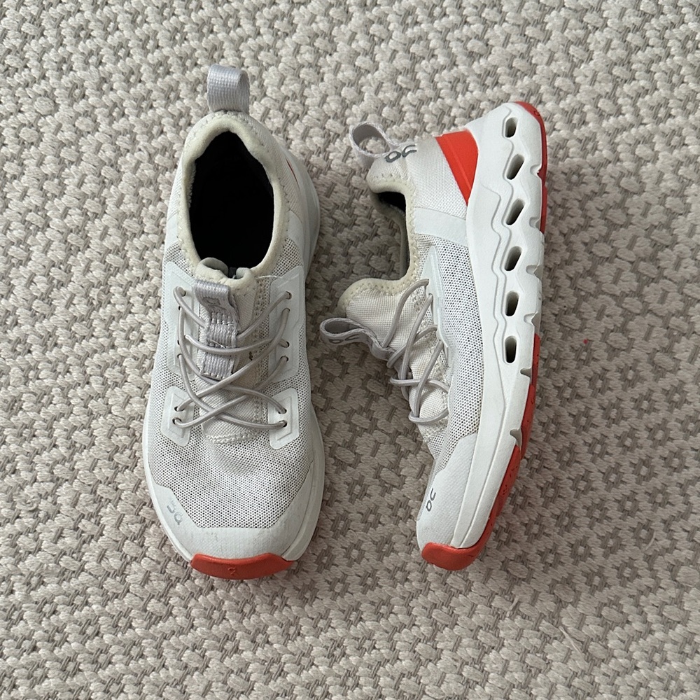 On Running White and Orange Athletic Shoes